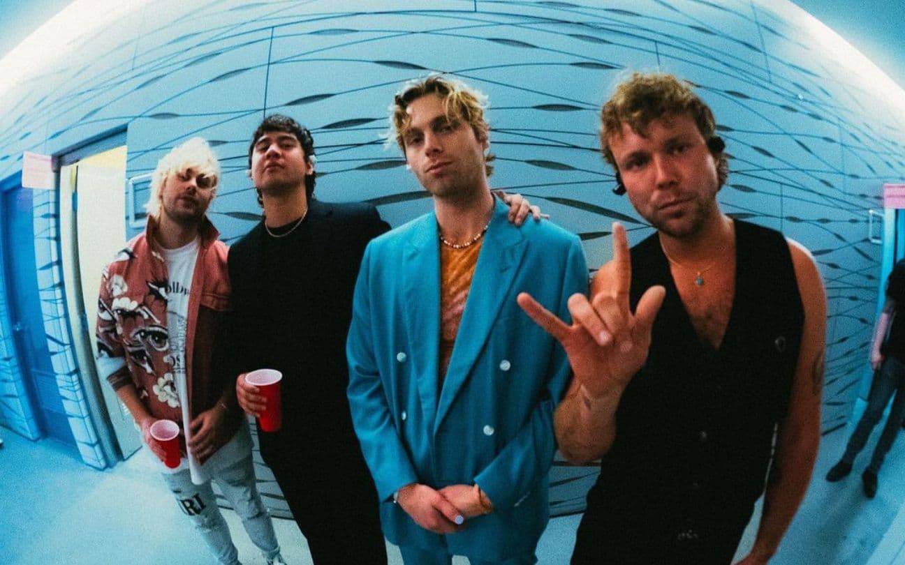 Membros da banda 5 Seconds of Summer posam para foto nos bastidores de show